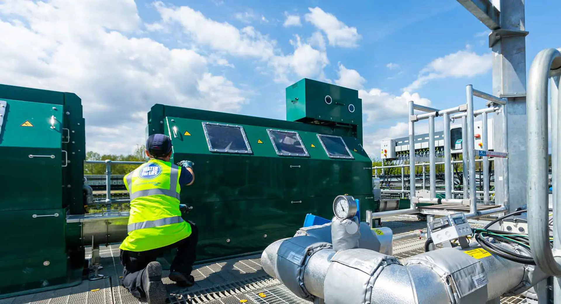 An employee inspecting machinery